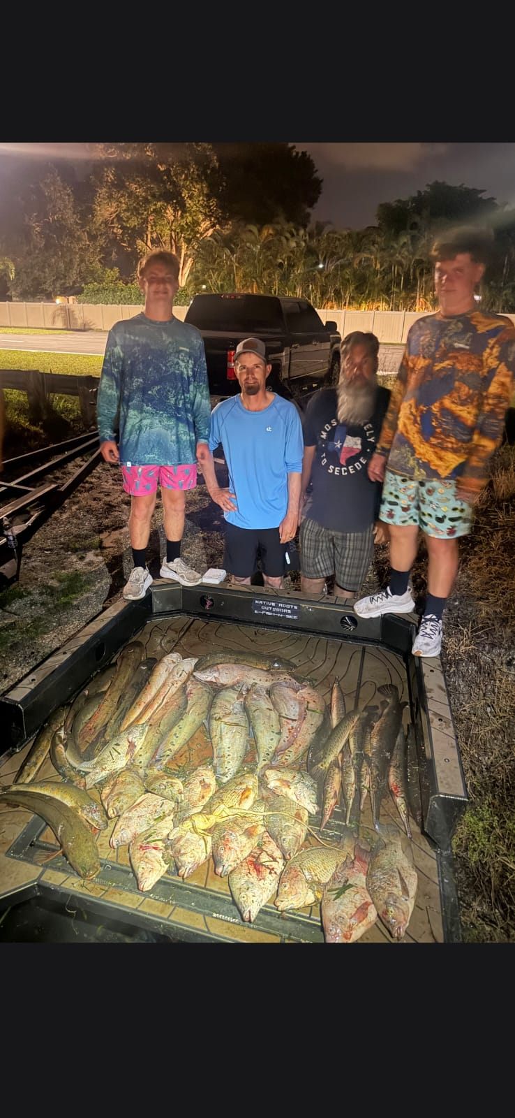 Native Roots Outdoors bowfishing trip photo with guests, fish, boat lights, and South Florida water