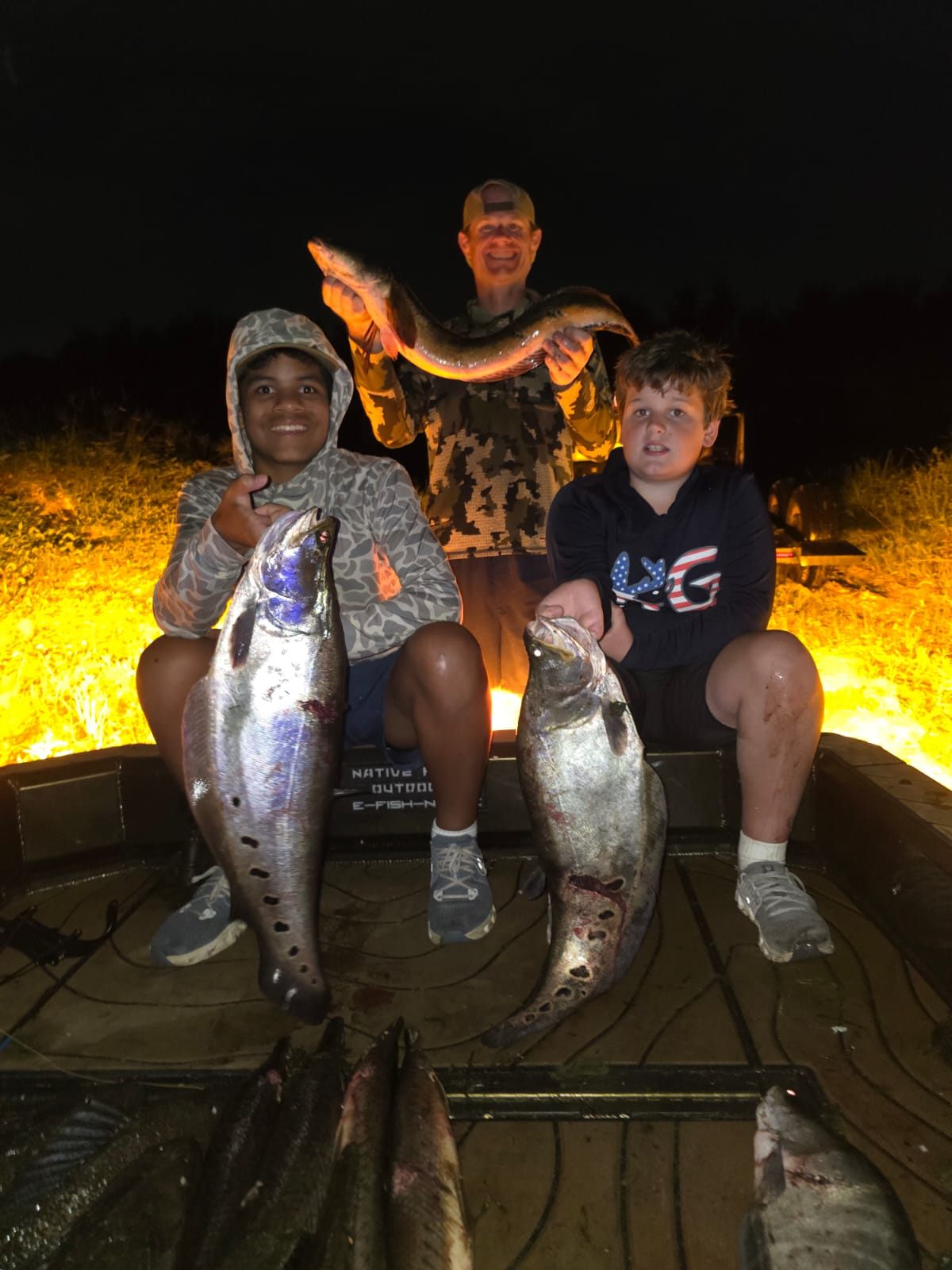 Native Roots Outdoors bowfishing trip photo with guests, fish, boat lights, and South Florida water