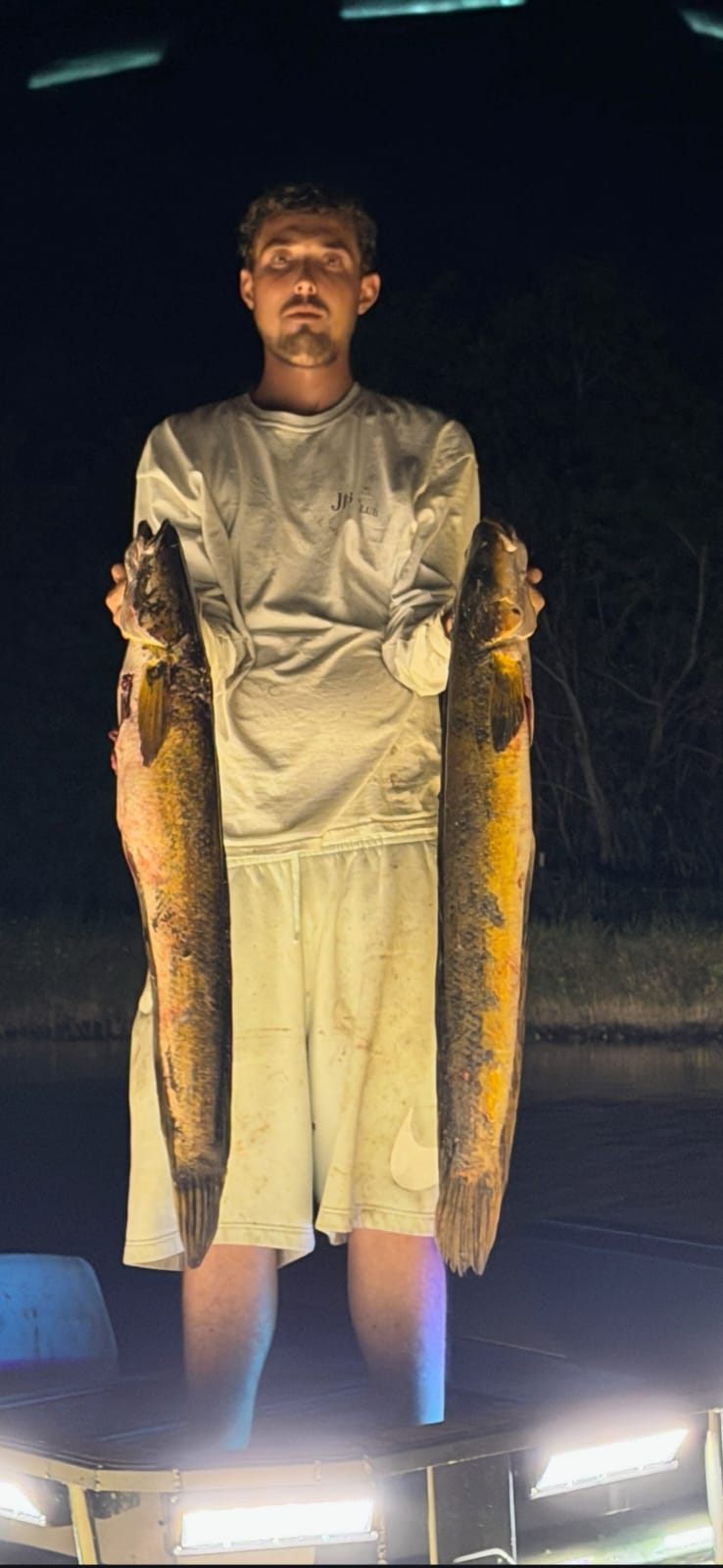 Native Roots Outdoors bowfishing trip photo with guests, fish, boat lights, and South Florida water