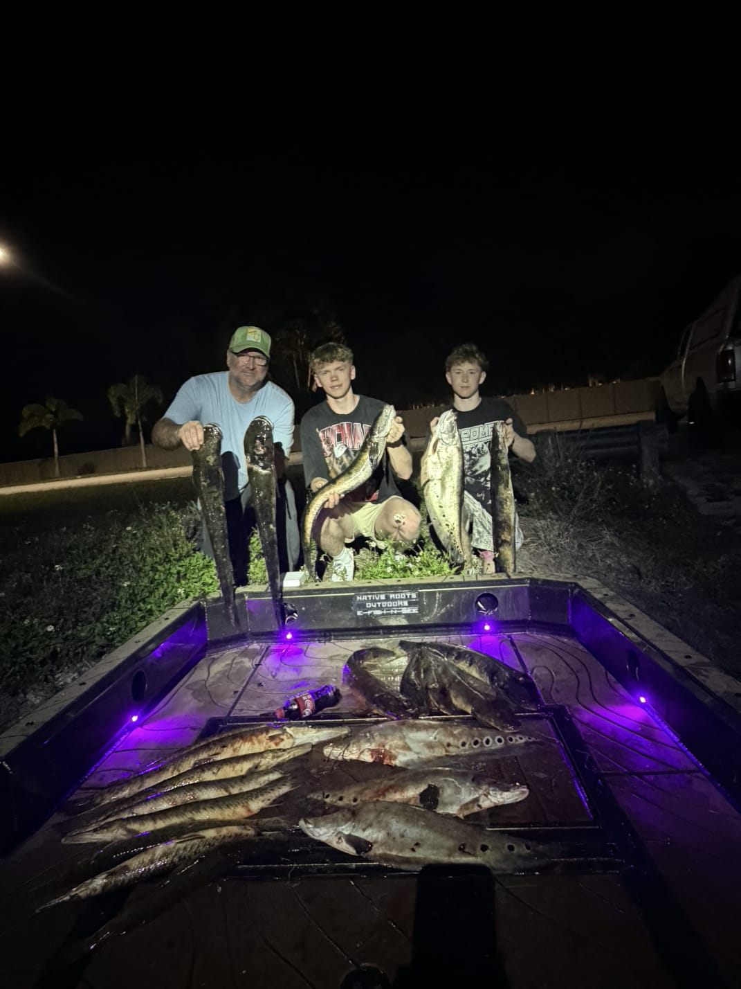 Native Roots Outdoors bowfishing trip photo with guests, fish, boat lights, and South Florida water