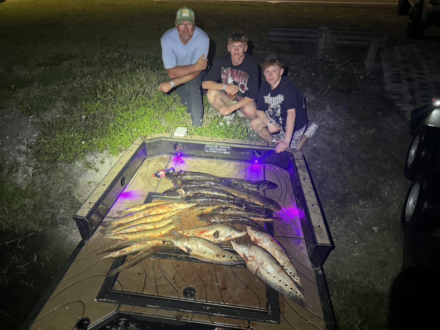 Native Roots Outdoors bowfishing trip photo with guests, fish, boat lights, and South Florida water