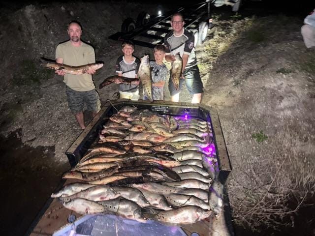 Native Roots Outdoors bowfishing trip photo with guests, fish, boat lights, and South Florida water
