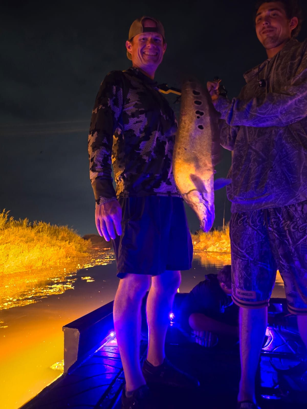 Native Roots Outdoors bowfishing trip photo with guests, fish, boat lights, and South Florida water