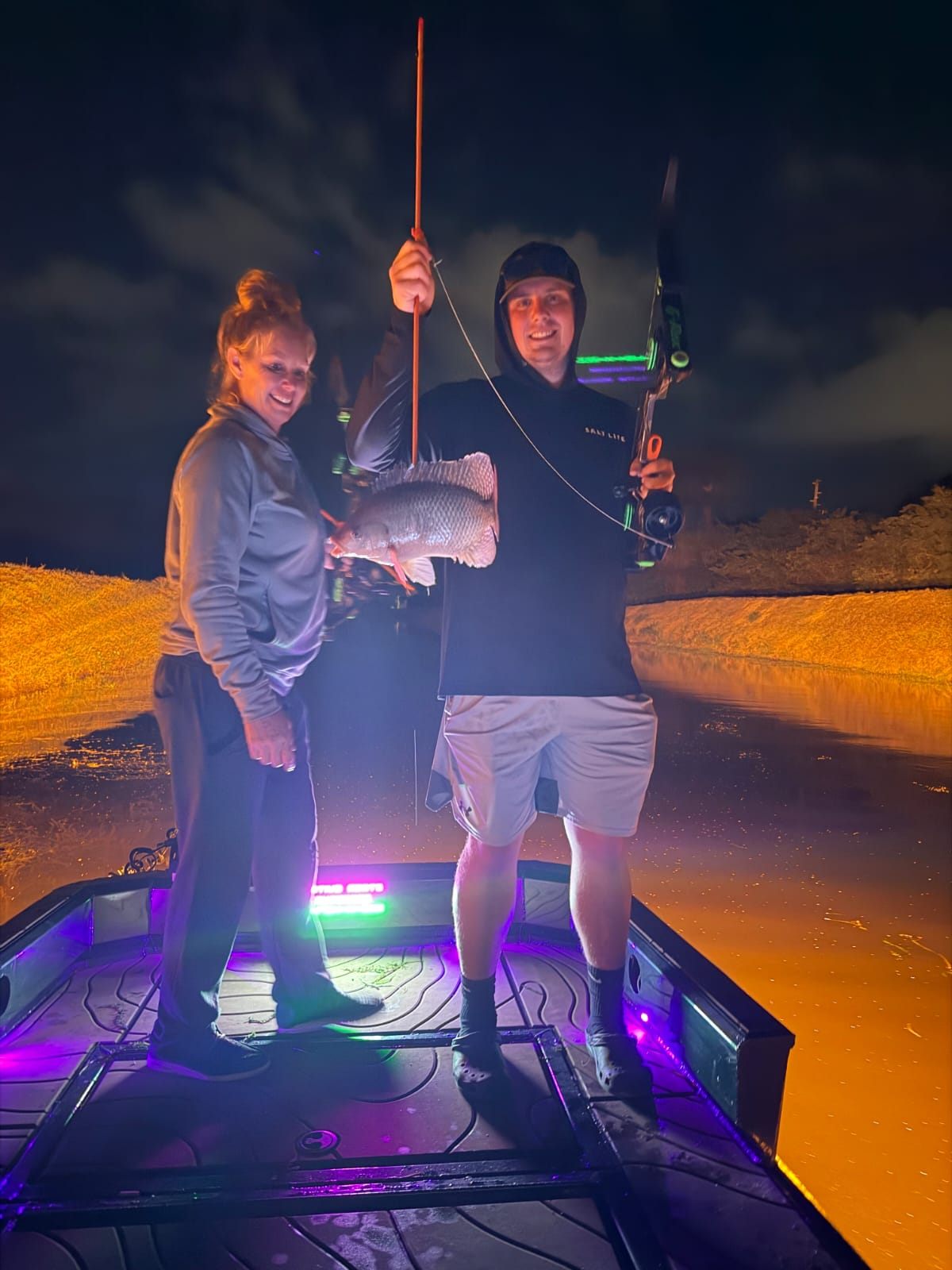 Native Roots Outdoors bowfishing trip photo with guests, fish, boat lights, and South Florida water