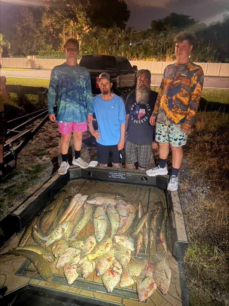 Native Roots Outdoors bowfishing trip photo with guests, fish, boat lights, and South Florida water