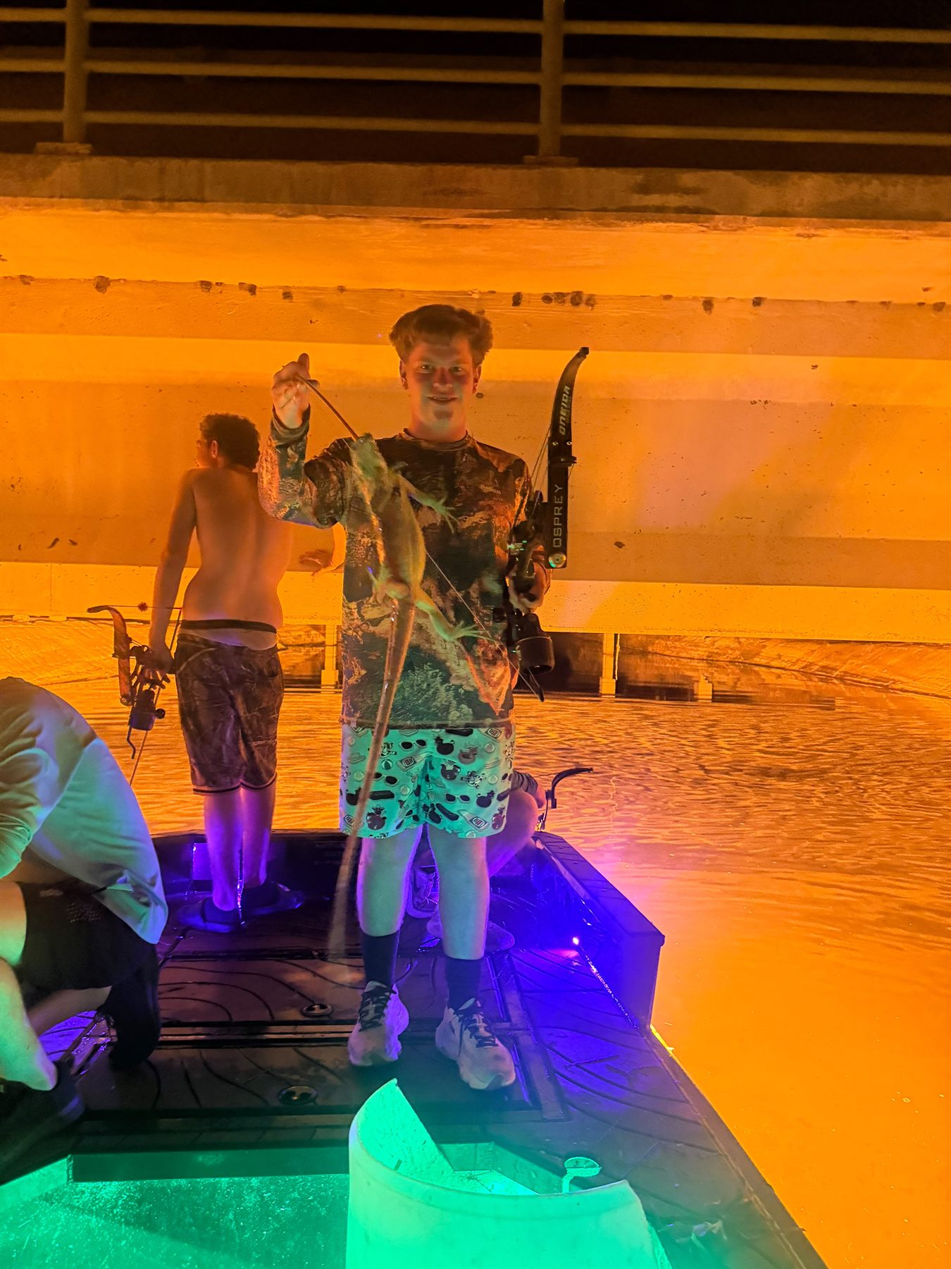 Native Roots Outdoors bowfishing trip photo with guests, fish, boat lights, and South Florida water