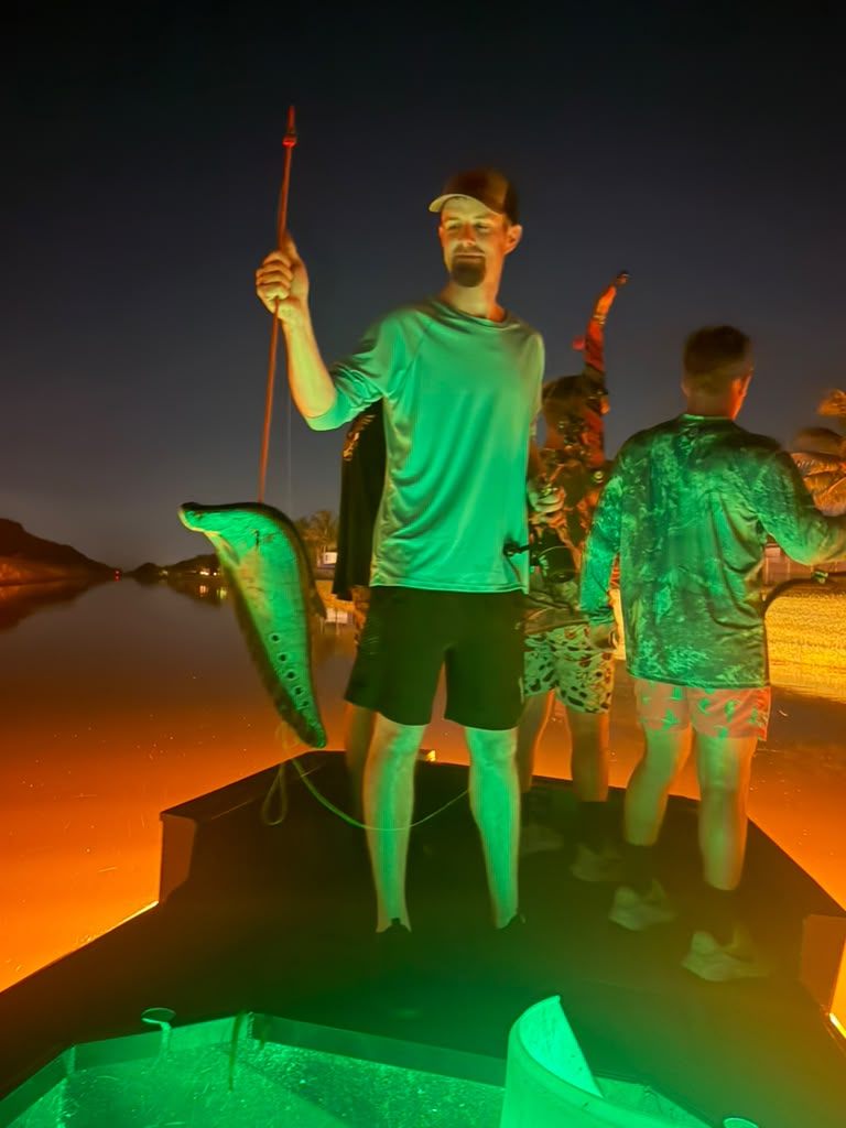 Native Roots Outdoors bowfishing trip photo with guests, fish, boat lights, and South Florida water