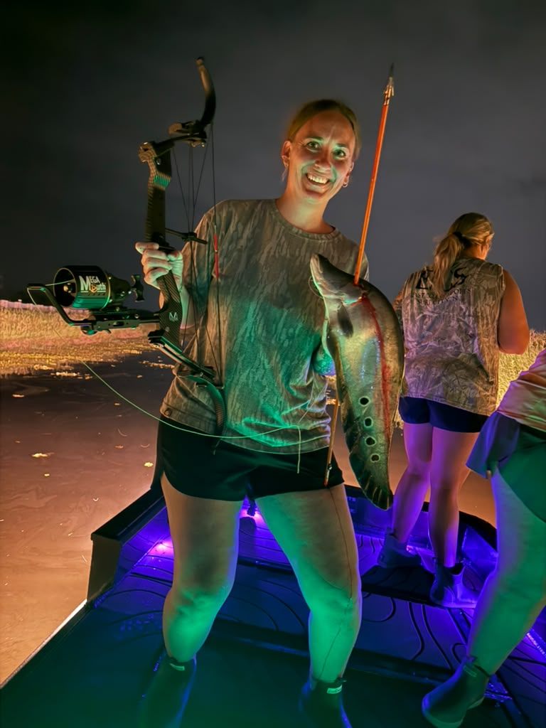 Native Roots Outdoors bowfishing trip photo with guests, fish, boat lights, and South Florida water