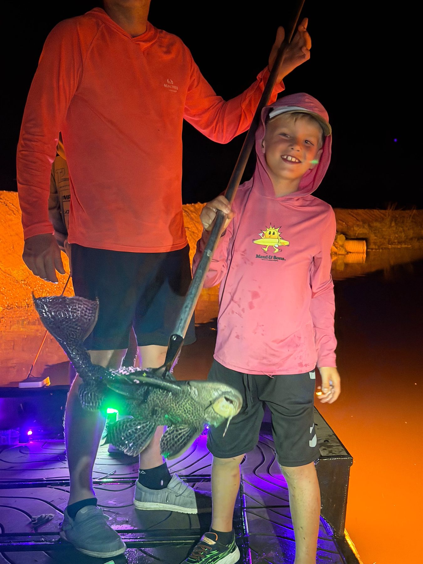 Native Roots Outdoors bowfishing trip photo with guests, fish, boat lights, and South Florida water
