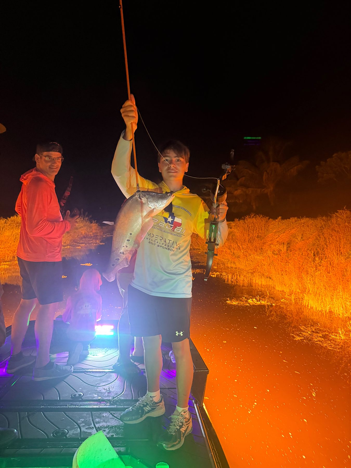 Native Roots Outdoors bowfishing trip photo with guests, fish, boat lights, and South Florida water