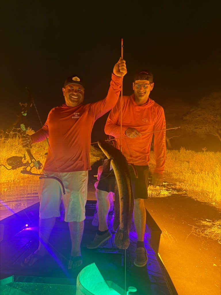 Native Roots Outdoors bowfishing trip photo with guests, fish, boat lights, and South Florida water