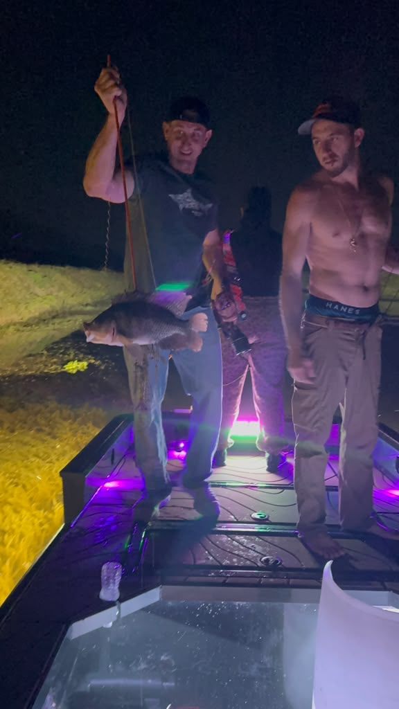 Native Roots Outdoors bowfishing trip photo with guests, fish, boat lights, and South Florida water