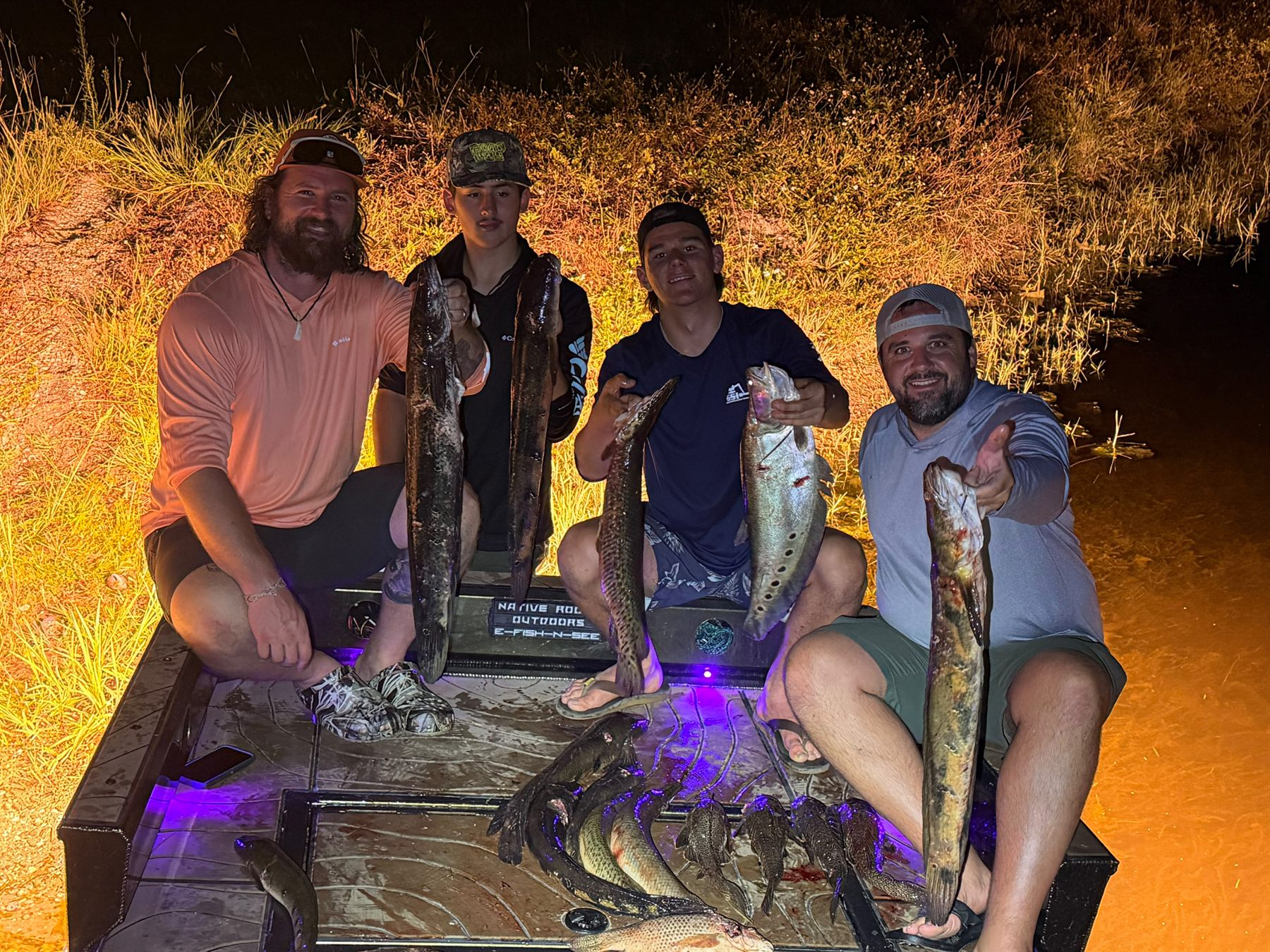 Native Roots Outdoors bowfishing trip photo with guests, fish, boat lights, and South Florida water