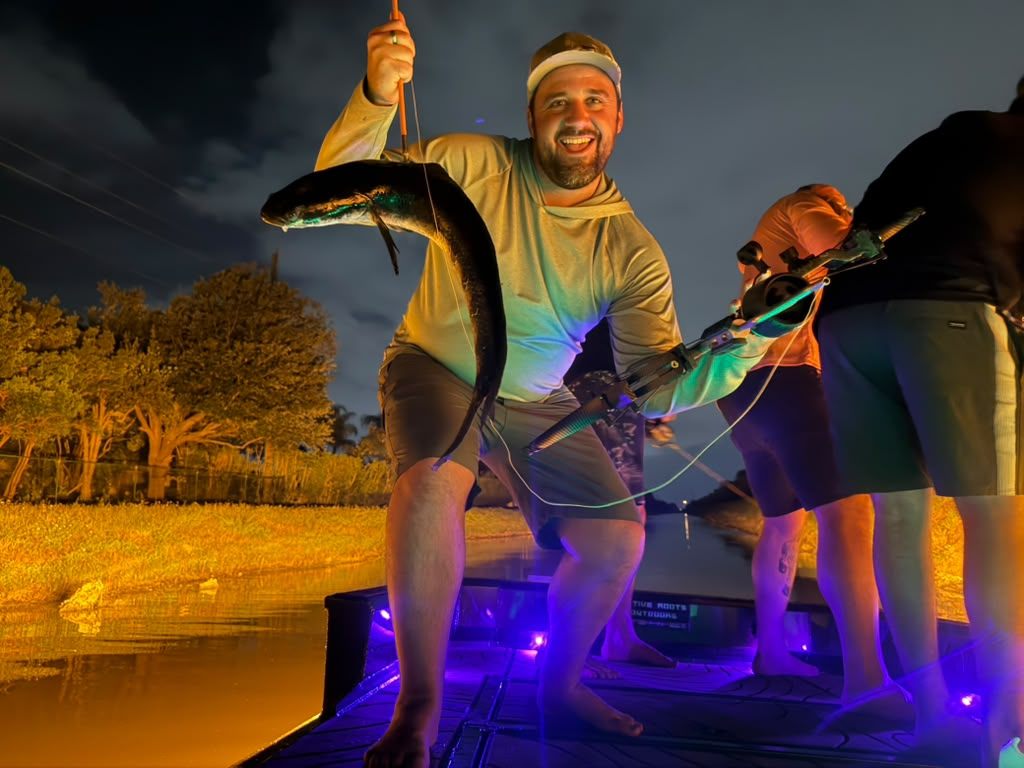 Native Roots Outdoors bowfishing trip photo with guests, fish, boat lights, and South Florida water