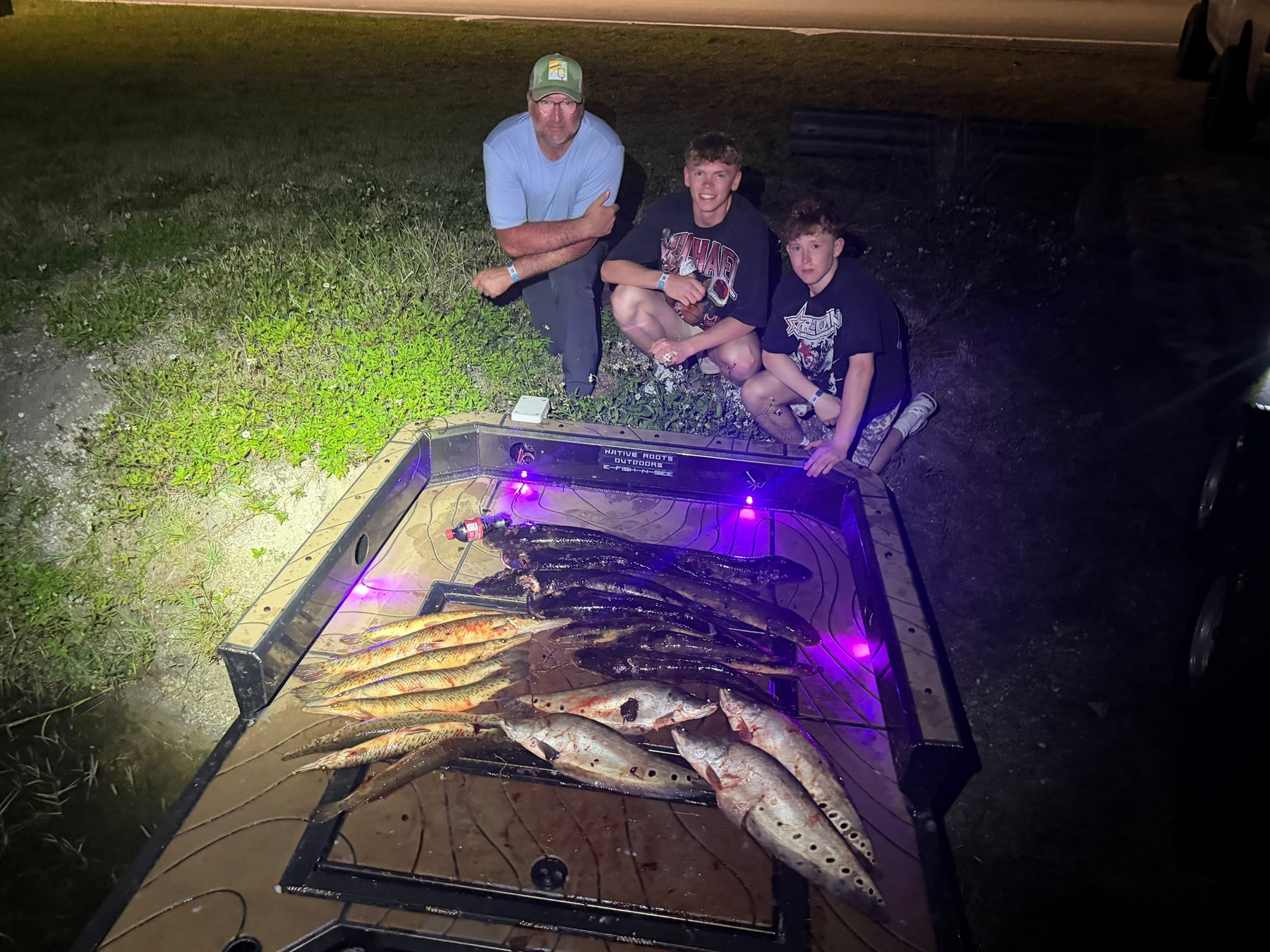 Native Roots Outdoors bowfishing trip photo with guests, fish, boat lights, and South Florida water