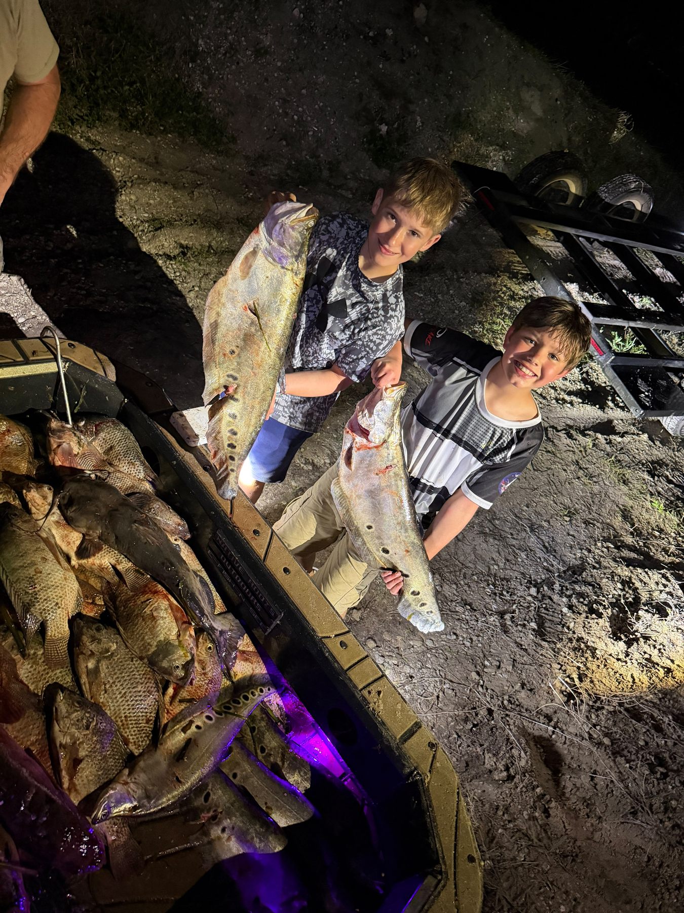 Native Roots Outdoors bowfishing trip photo with guests, fish, boat lights, and South Florida water