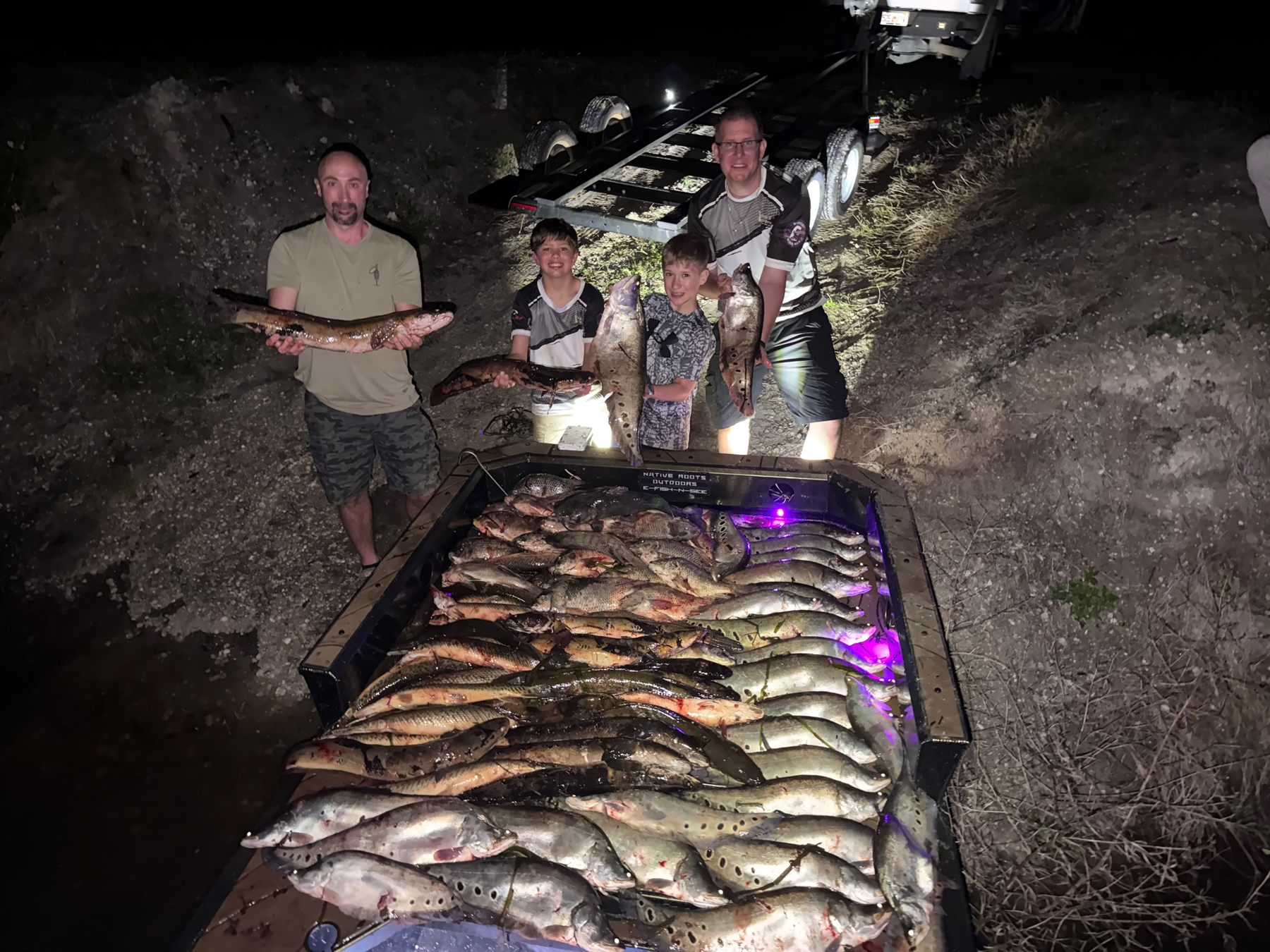 Native Roots Outdoors bowfishing trip photo with guests, fish, boat lights, and South Florida water
