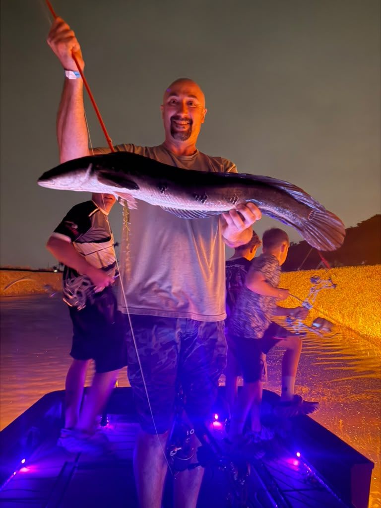 Native Roots Outdoors bowfishing trip photo with guests, fish, boat lights, and South Florida water