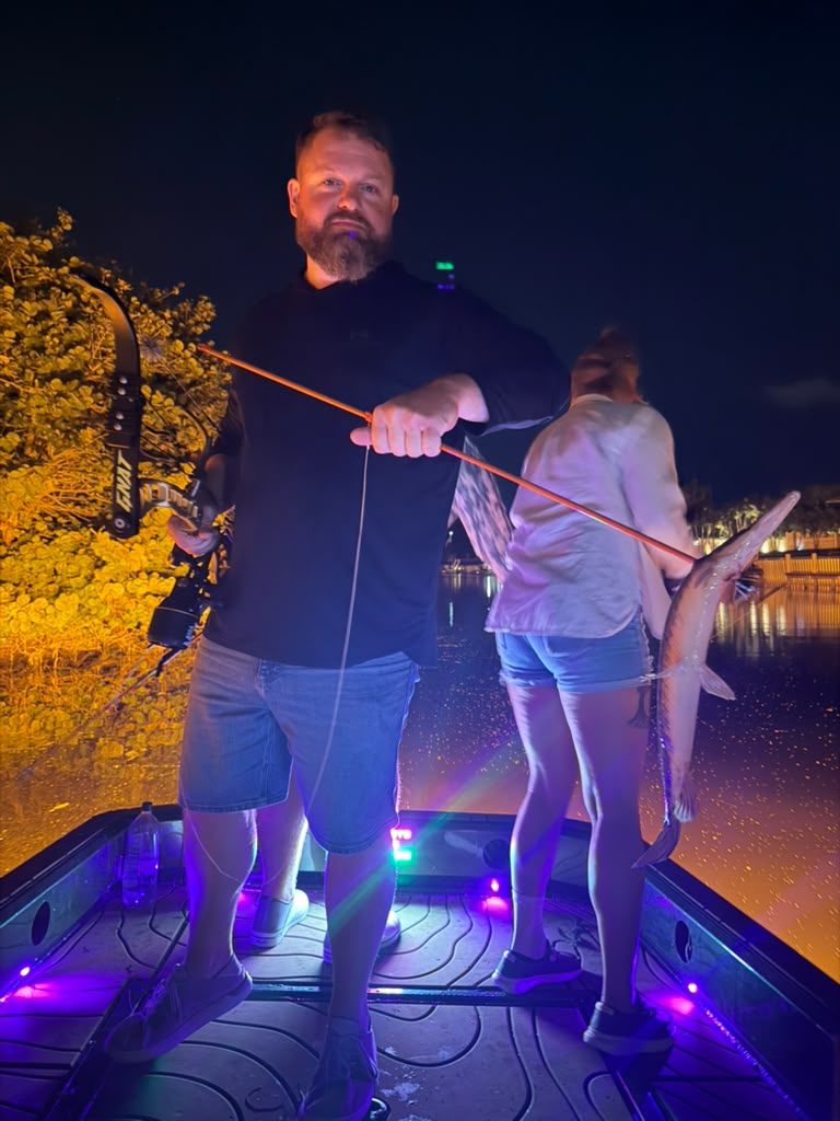 Native Roots Outdoors bowfishing trip photo with guests, fish, boat lights, and South Florida water