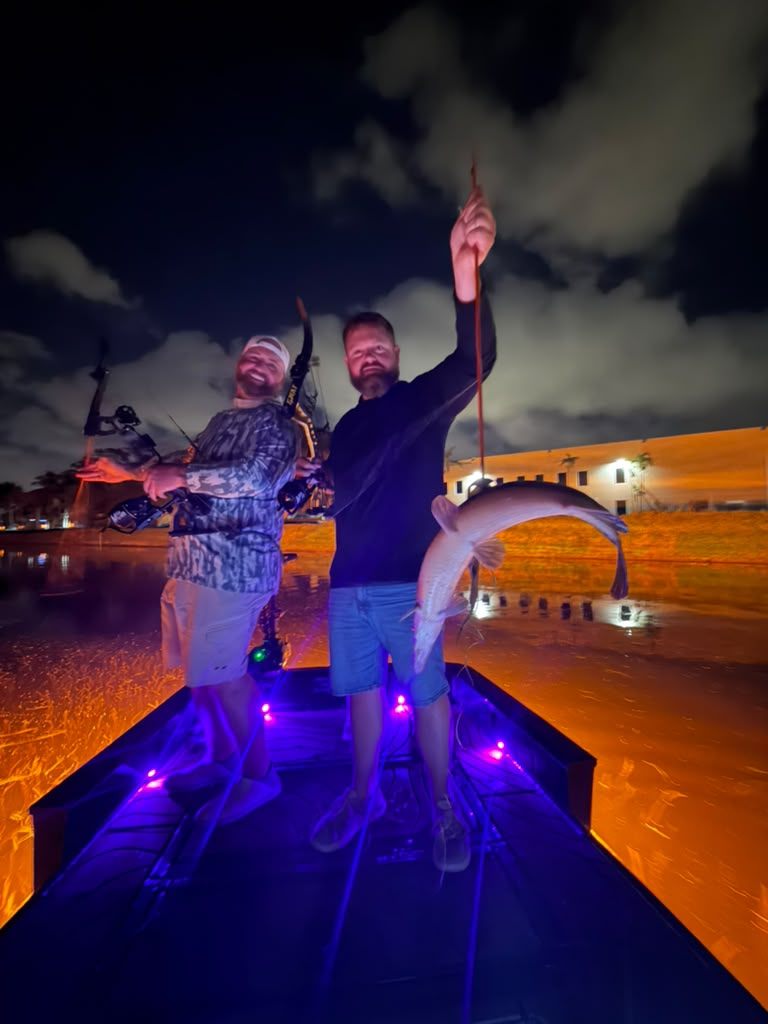 Native Roots Outdoors bowfishing trip photo with guests, fish, boat lights, and South Florida water