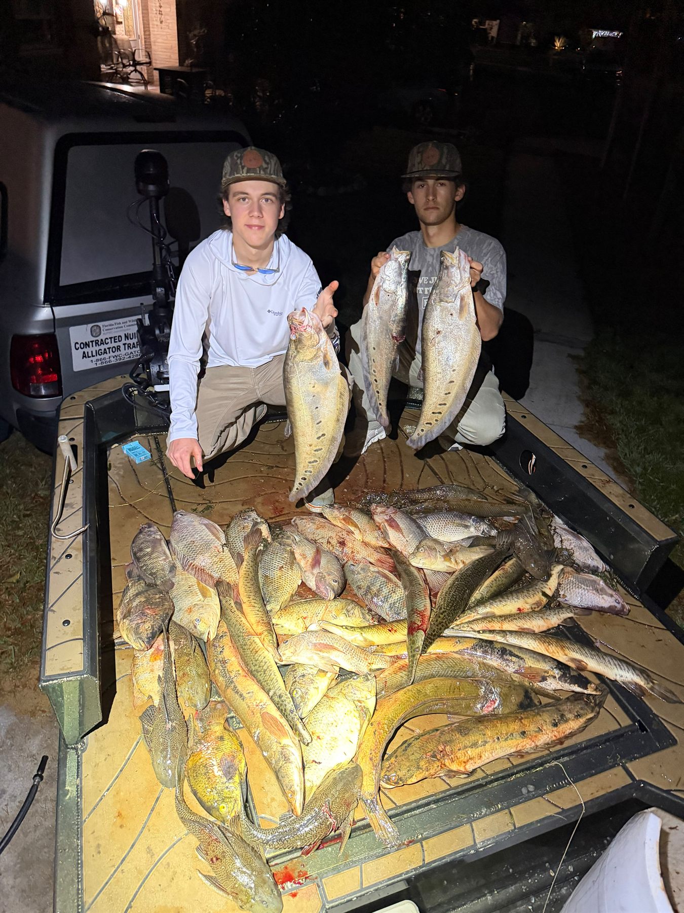 Native Roots Outdoors bowfishing trip photo with guests, fish, boat lights, and South Florida water
