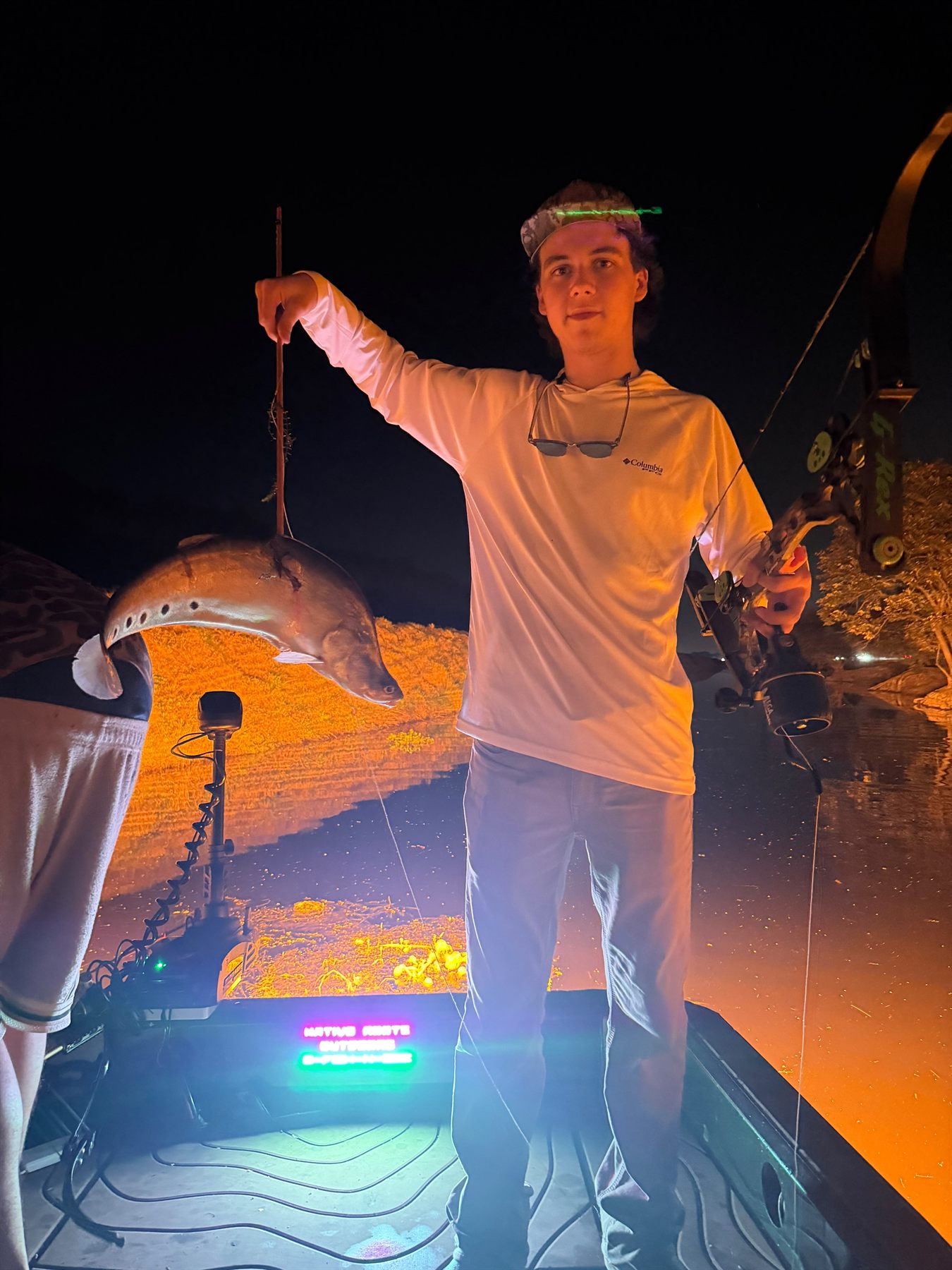 Native Roots Outdoors bowfishing trip photo with guests, fish, boat lights, and South Florida water