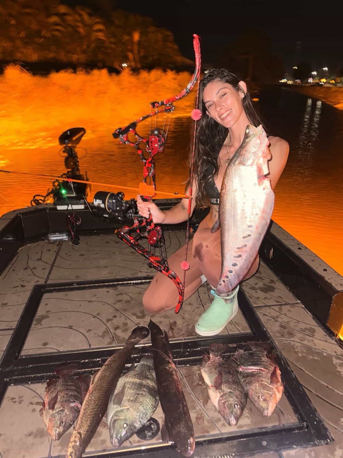 Native Roots Outdoors bowfishing trip photo with guests, fish, boat lights, and South Florida water