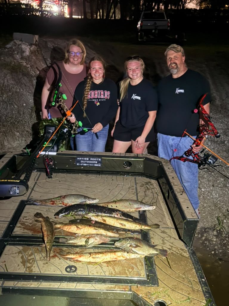 Native Roots Outdoors bowfishing trip photo with guests, fish, boat lights, and South Florida water