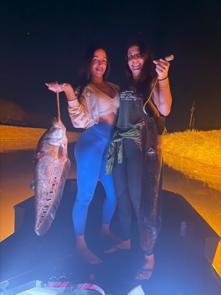 Native Roots Outdoors bowfishing trip photo with guests, fish, boat lights, and South Florida water