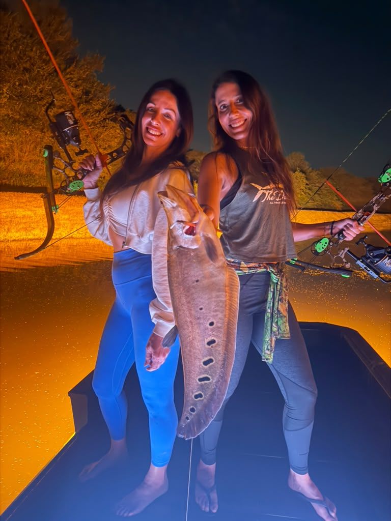 Native Roots Outdoors bowfishing trip photo with guests, fish, boat lights, and South Florida water