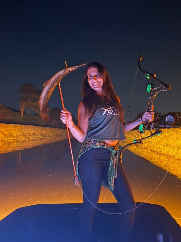 Native Roots Outdoors bowfishing trip photo with guests, fish, boat lights, and South Florida water