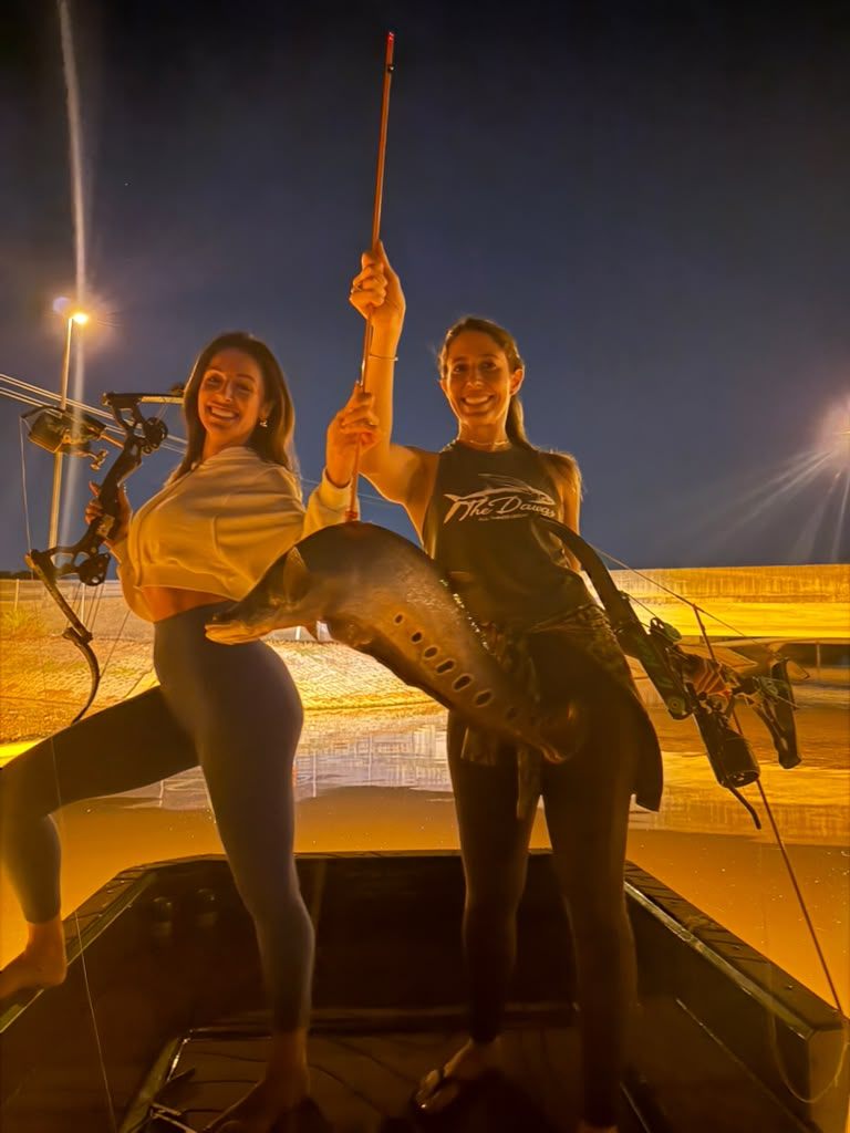 Native Roots Outdoors bowfishing trip photo with guests, fish, boat lights, and South Florida water