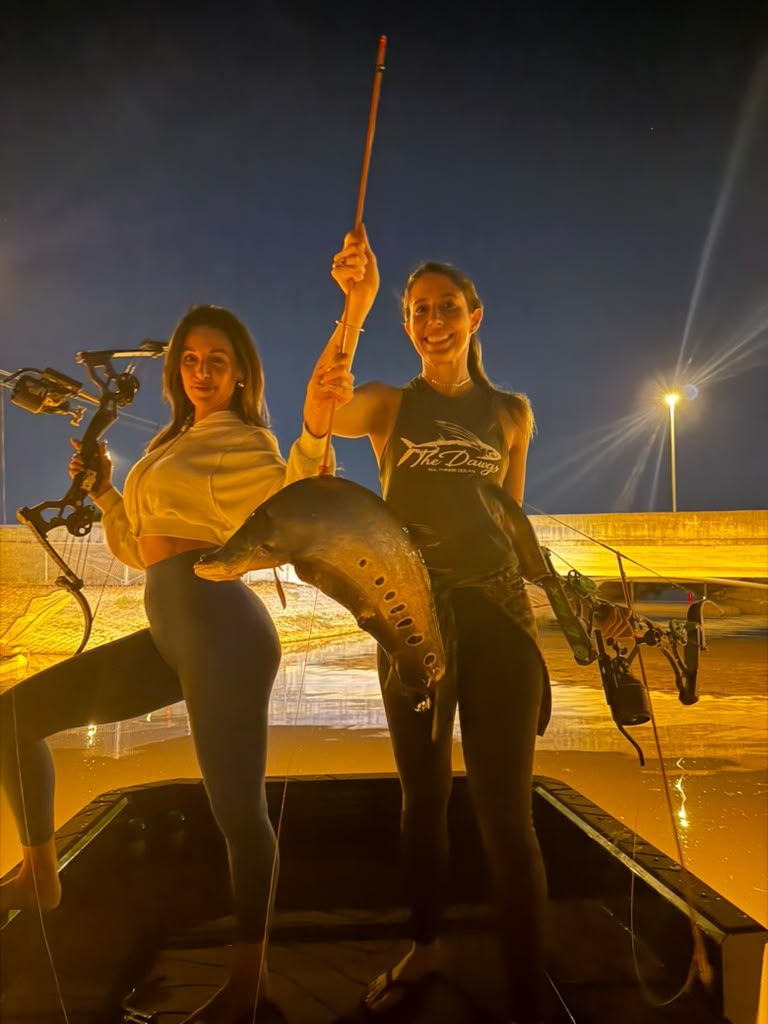 Native Roots Outdoors bowfishing trip photo with guests, fish, boat lights, and South Florida water