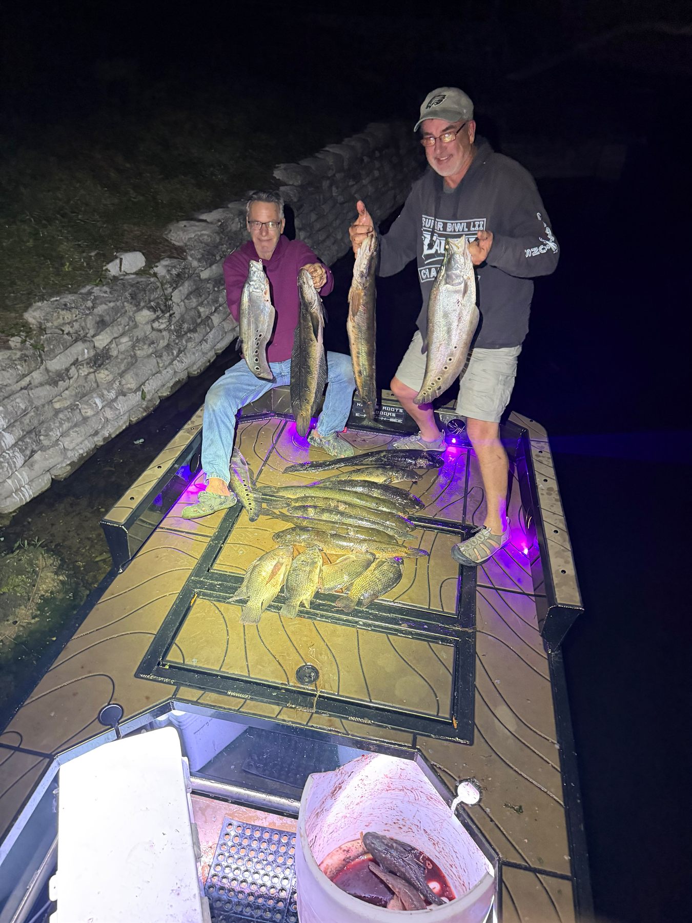 Native Roots Outdoors bowfishing trip photo with guests, fish, boat lights, and South Florida water