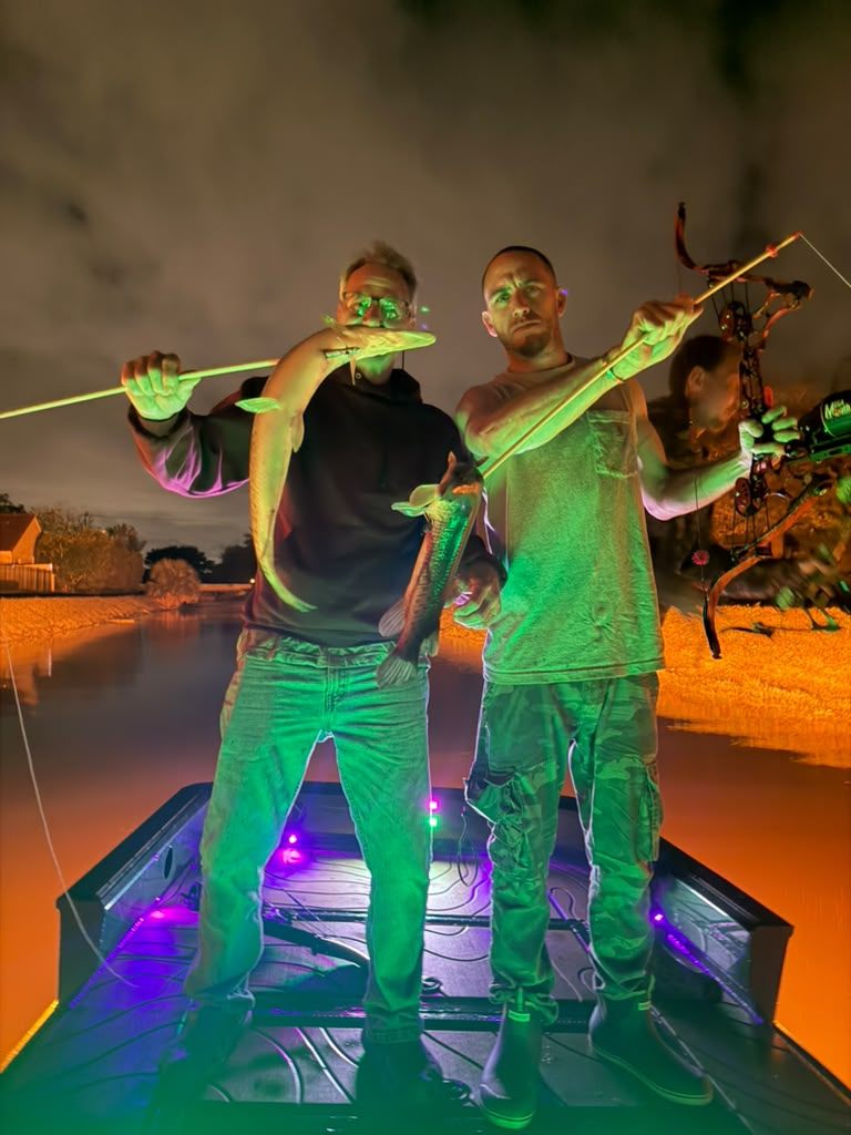 Native Roots Outdoors bowfishing trip photo with guests, fish, boat lights, and South Florida water