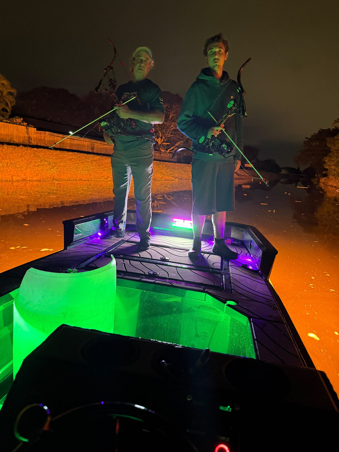 Native Roots Outdoors bowfishing trip photo with guests, fish, boat lights, and South Florida water