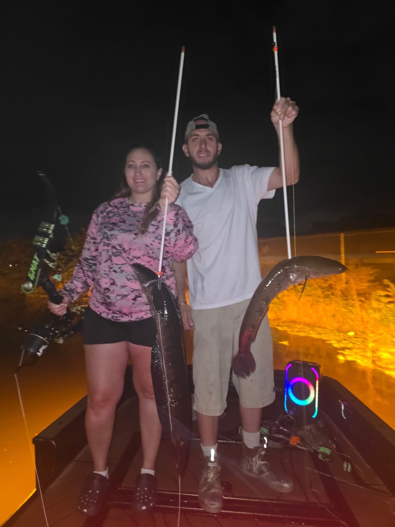 Native Roots Outdoors bowfishing trip photo with guests, fish, boat lights, and South Florida water