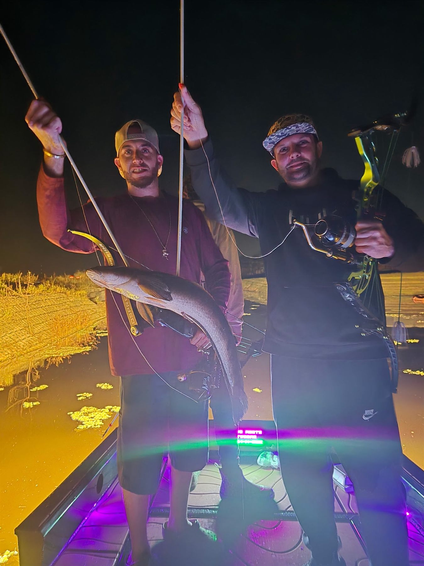 Native Roots Outdoors bowfishing trip photo with guests, fish, boat lights, and South Florida water